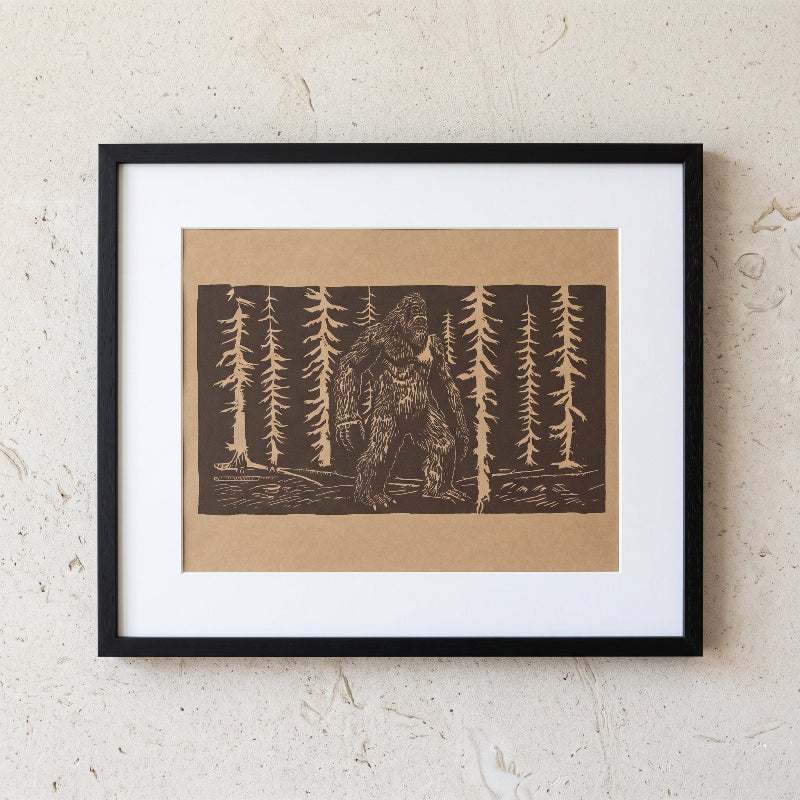 Bigfoot linocut print in a forest on medium brown paper, limited edition folklore artwork
