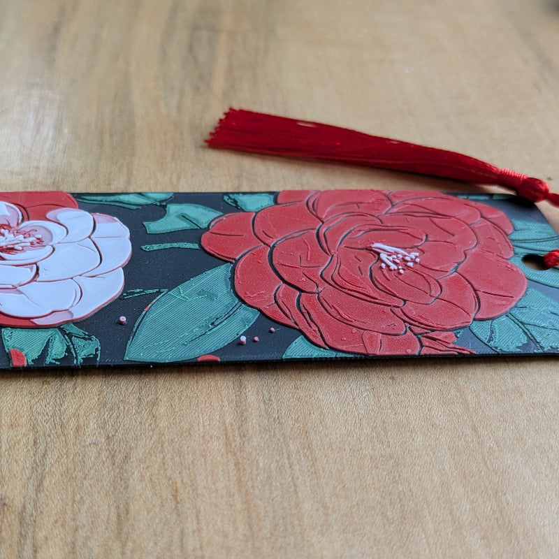 Close up of textured camellia floral bookmark surface and illustration details