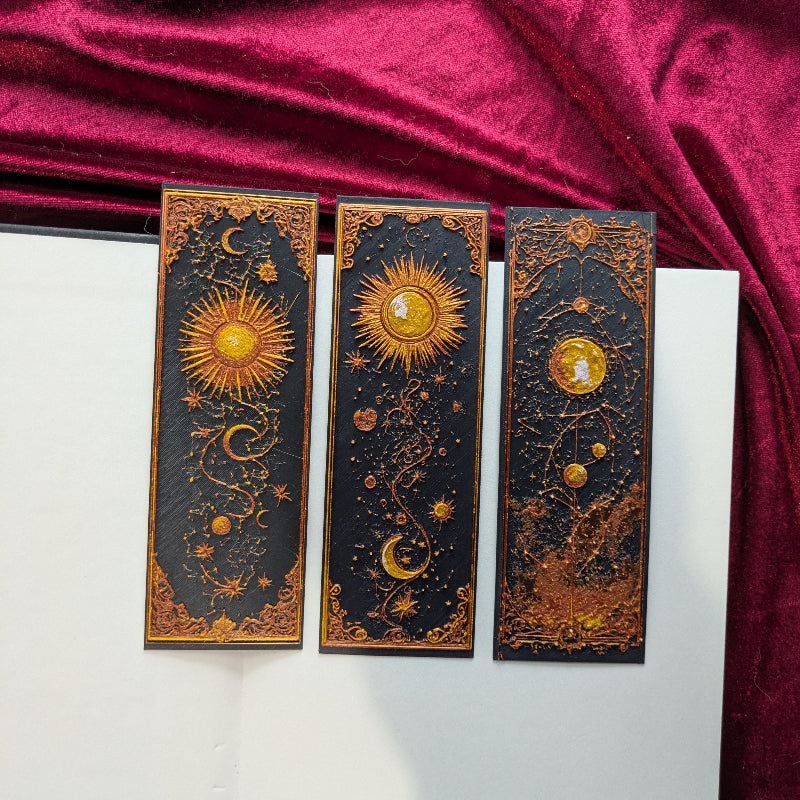 Three dimensional celestial bookmarks featuring Sun and Moon, Celestial Balance, and Cosmic designs