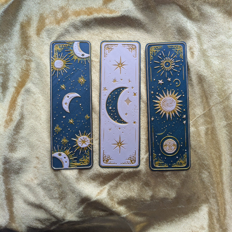 Three-piece celestial bookmark set featuring moon star and sun designs