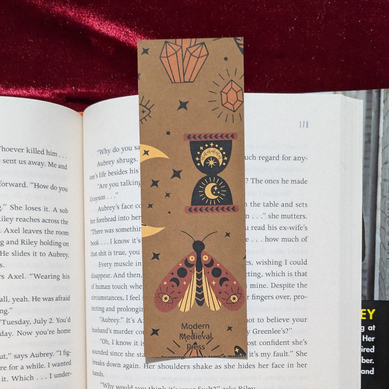 Back of bookmark featuring folkloric moth illustration and Modern Medieval Press branding