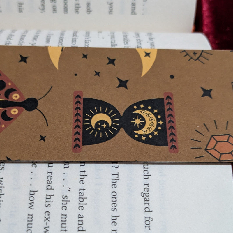 Close up of moth illustration celestial markings and ink texture on kraft bookmark