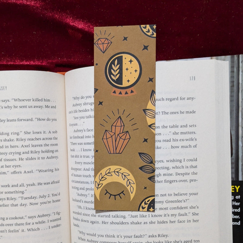 Front of celestial moth sigil bookmark with medieval inspired celestial symbols on kraft paper