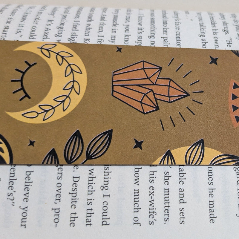 Close up of kraft paper texture and layered ink details on celestial moth sigil bookmark