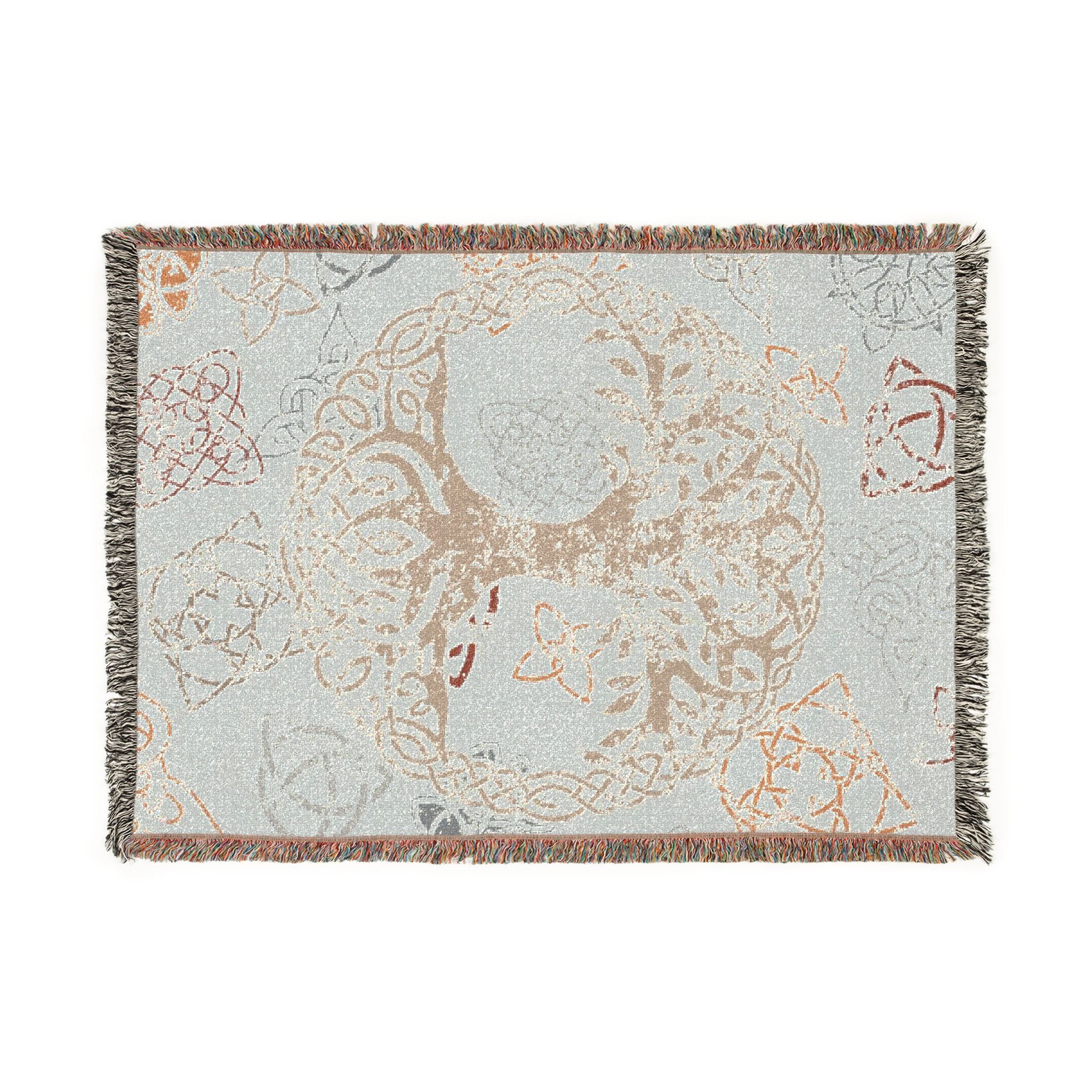 Flat lay of Celtic Tree of Life woven blanket in cream and autumn tones with knotwork pattern and multicolor fringe