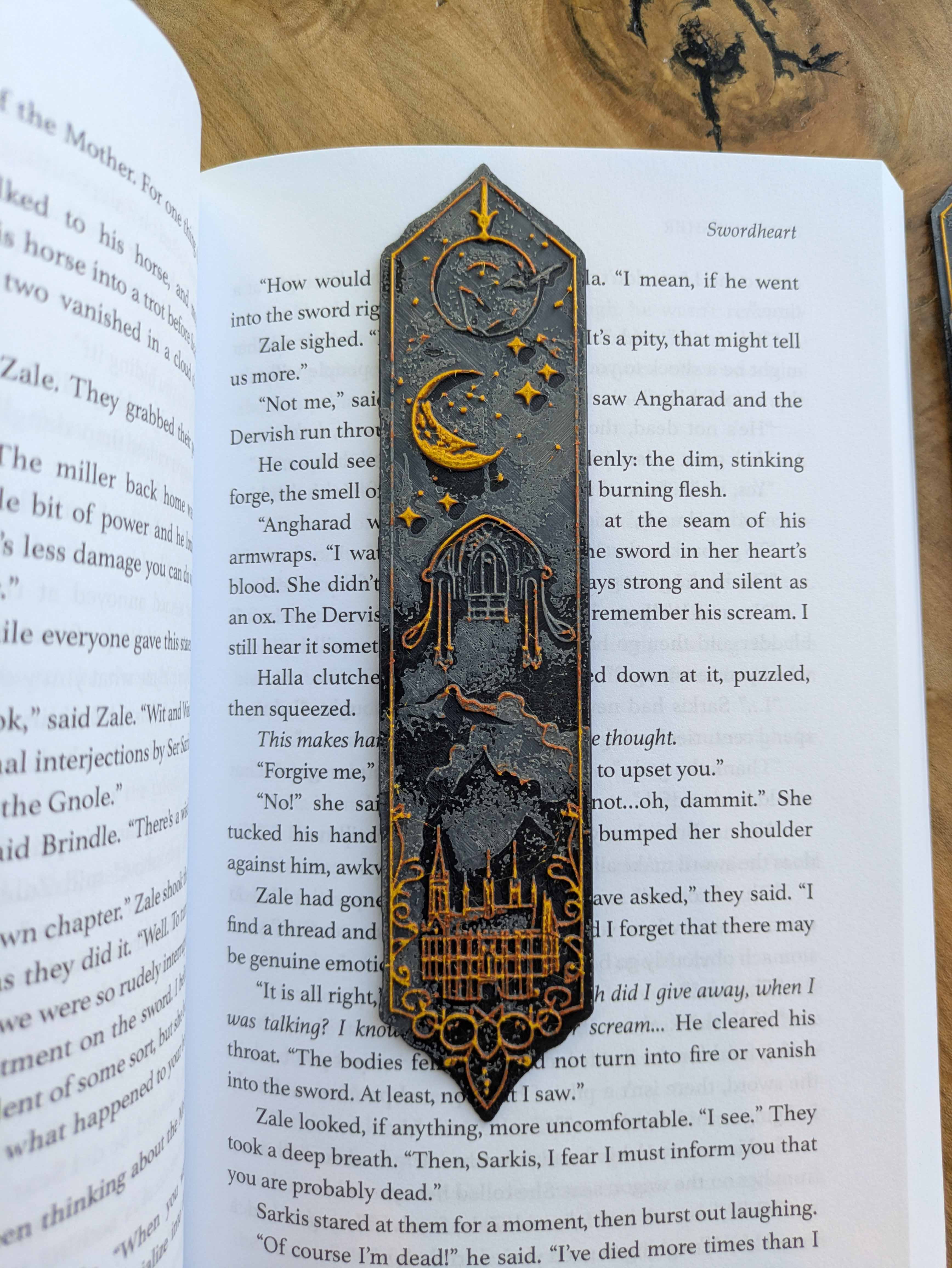 Handcrafted black bookmark with gold accents featuring a crescent moon and castle design.