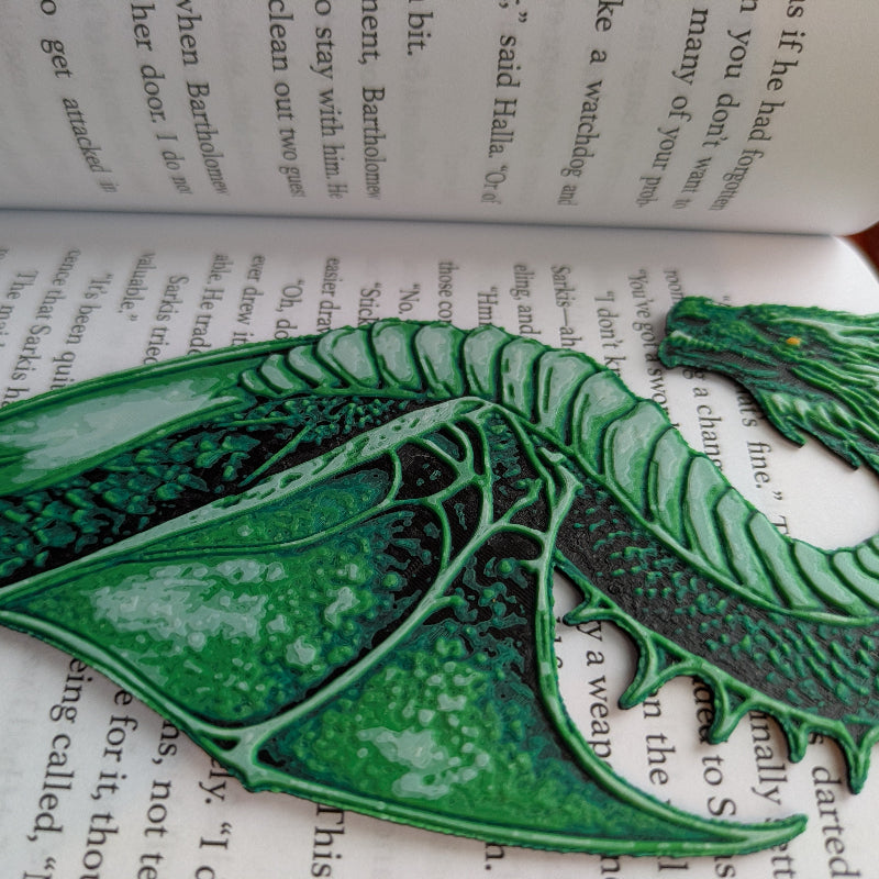 close-up of textured dragon scales and wings on green bookmark