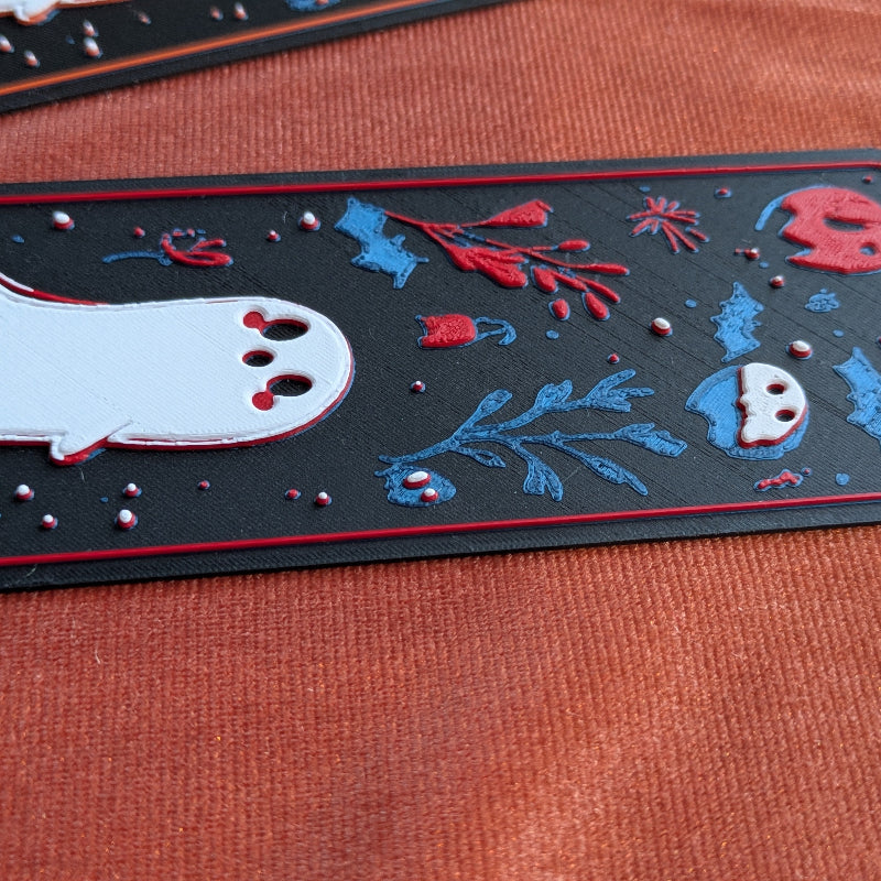 Close-up showing layered botanical details and ghost on Ghost Woodland bookmark.