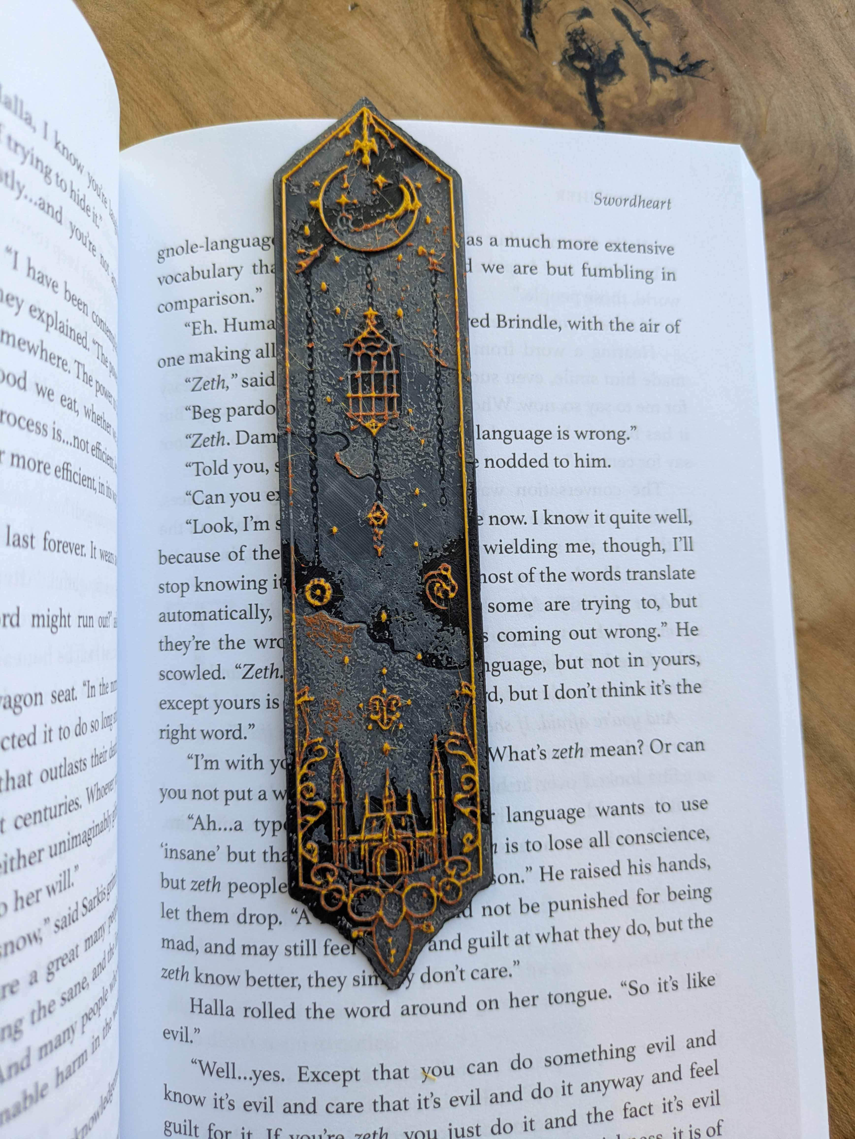 Handcrafted black bookmark with gold accents featuring an arched gothic castle and starry sky design.