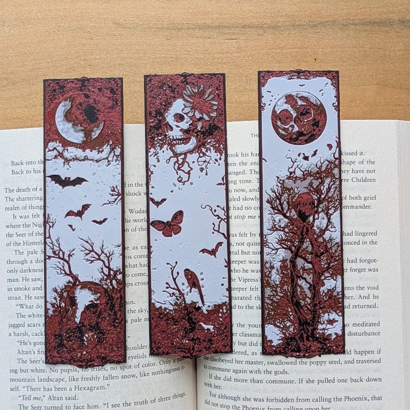 Set of three gothic folklore bookmarks with moon, skull, and raven designs