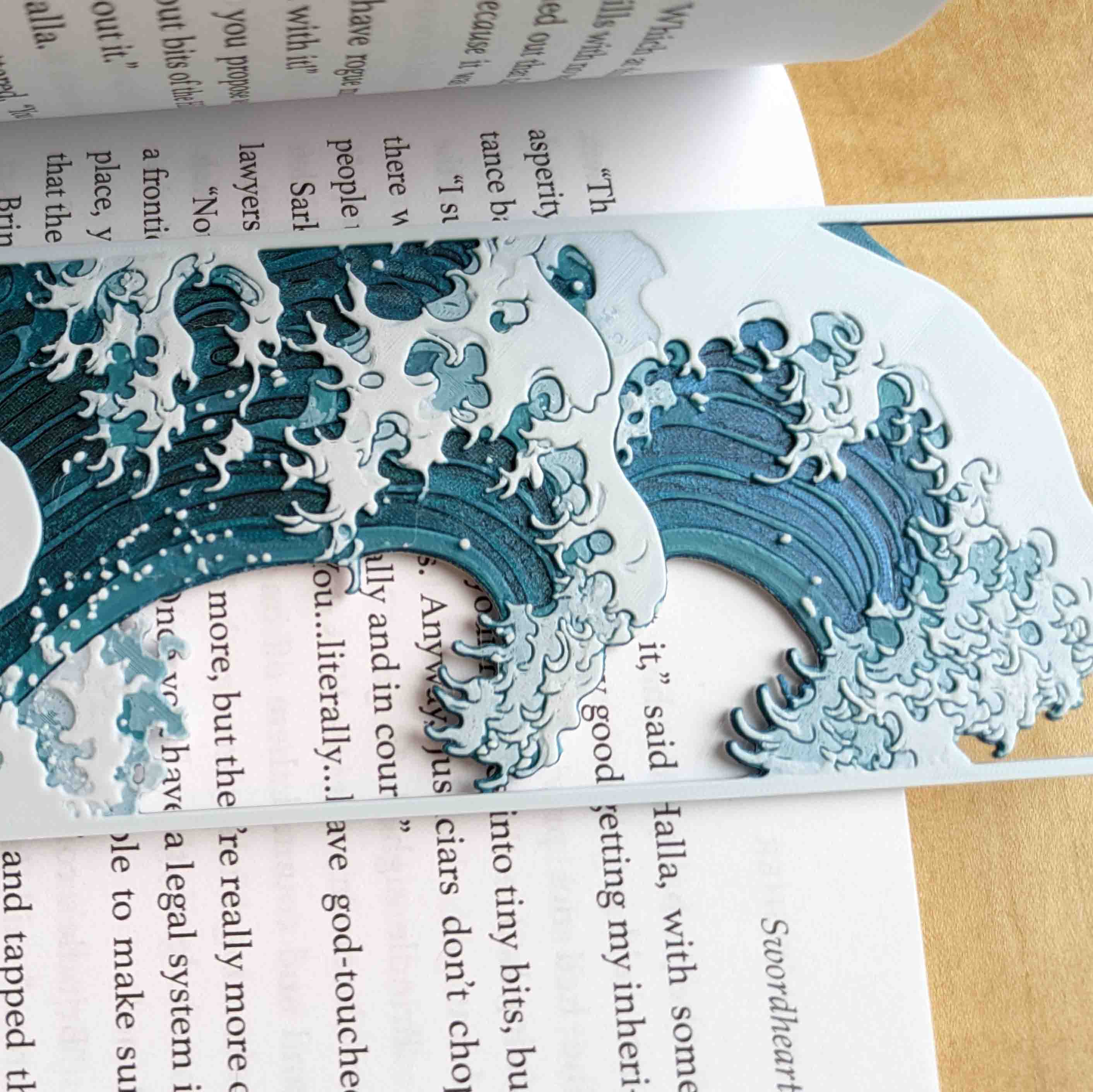 Close up showing layered color printing and raised texture on Japanese wave inspired bookmark