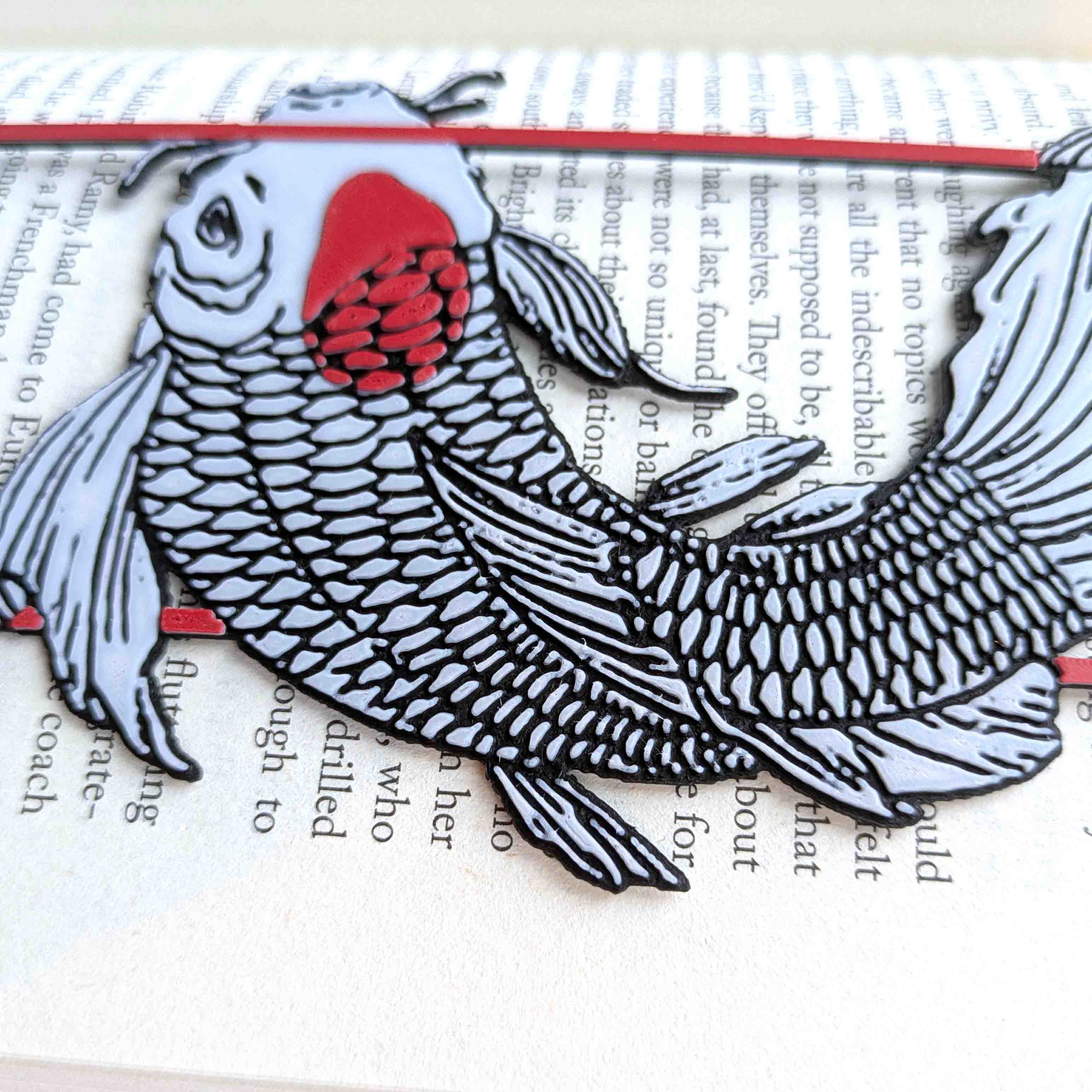 Close up of black tassel and red frame on koi fish bookmark