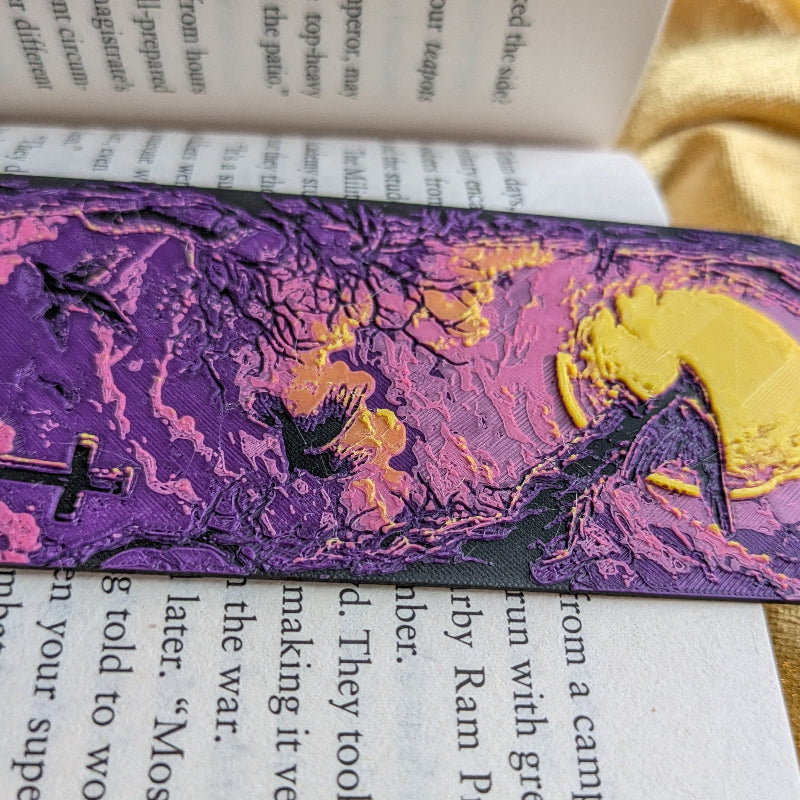 Close-up of textured purple and gold moonlit graveyard artwork on bookmark
