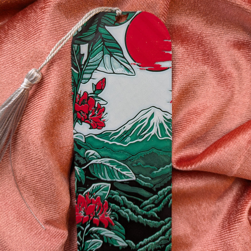 Close-up of Mount Fuji bookmark showing botanical details, red blossoms, and Japanese landscape artwork