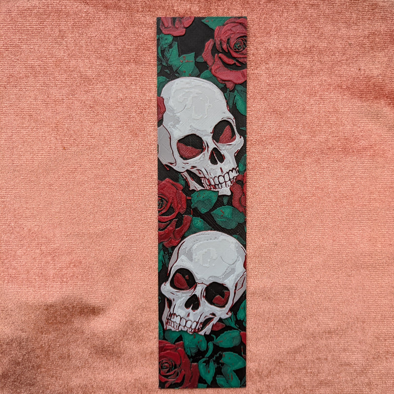 Gothic bookmark with white skulls and red roses on a black background