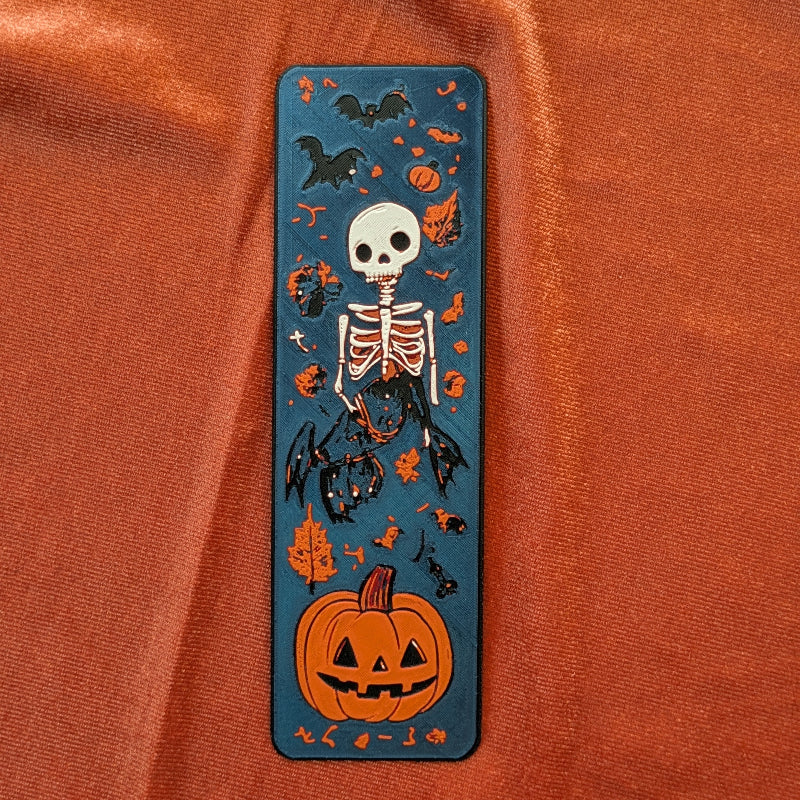 Textured 3D printed skeleton and bat bookmark with pumpkin and autumn leaves