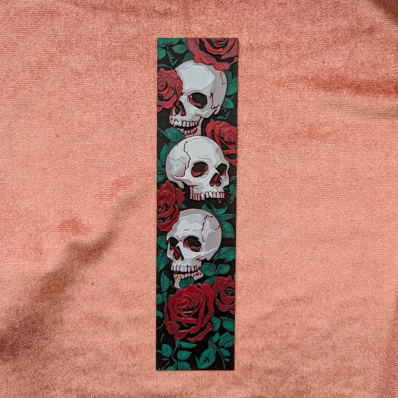 Skull and rose design on a pink fabric background