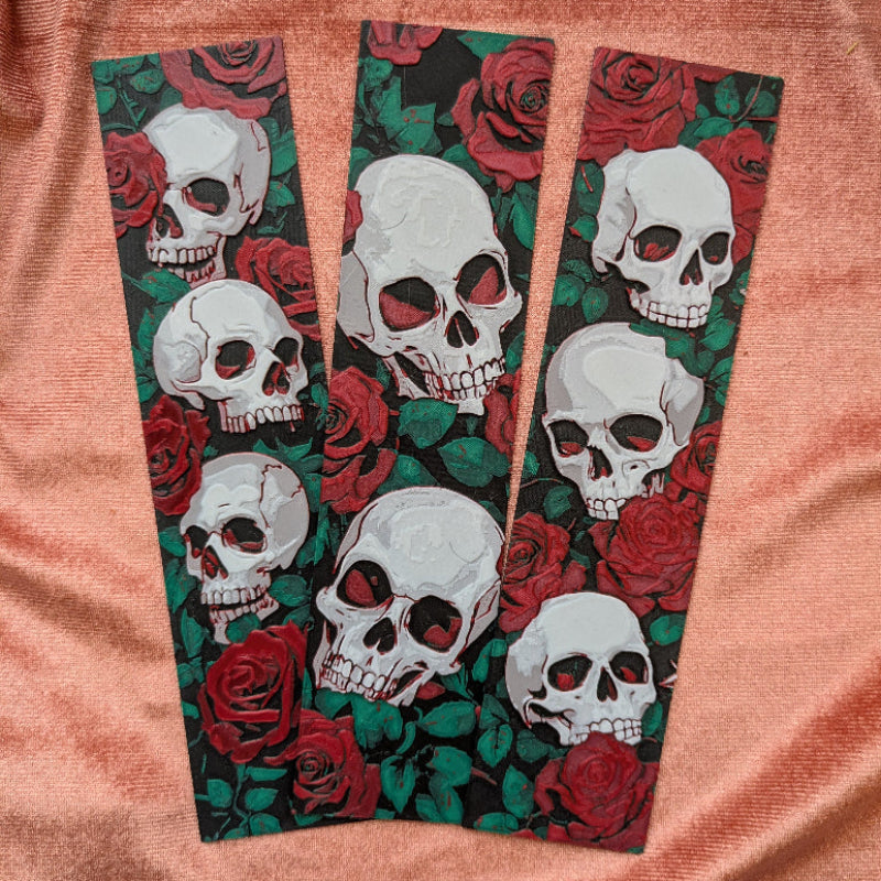 Horizontal gothic bookmark with repeating skull and rose artwork