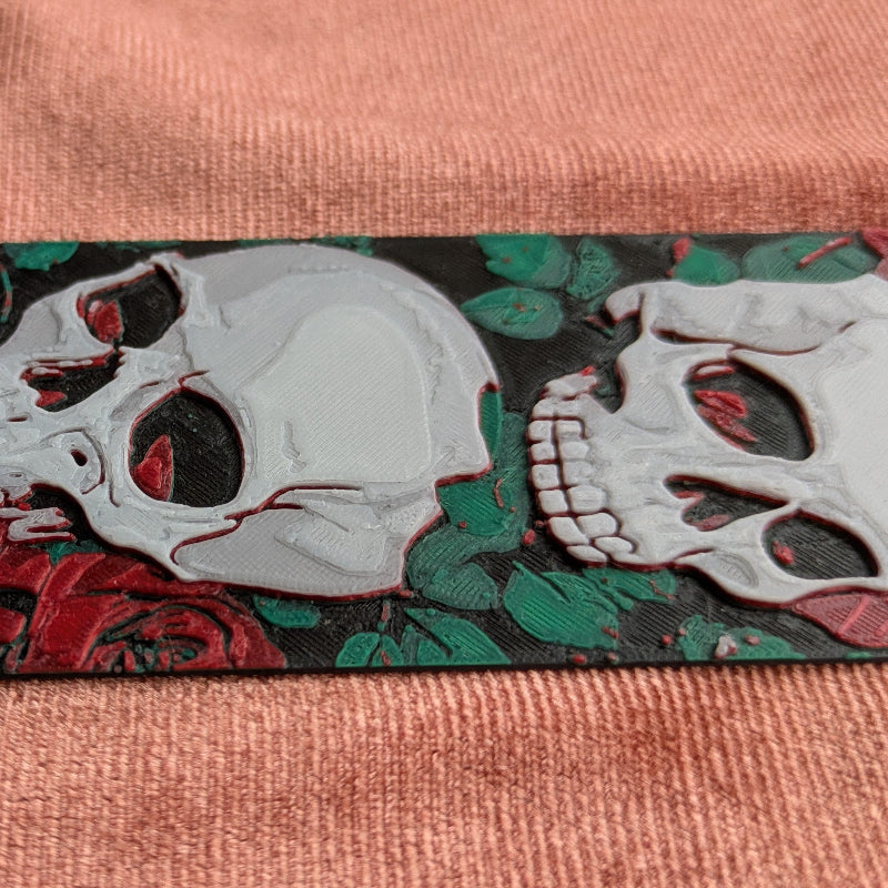 Close-up texture detail of gothic skull and rose horizontal bookmark