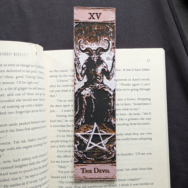 The Devil tarot bookmark in the Classic Edition, showing the horned figure and pentacle in copper-toned relief on a black background