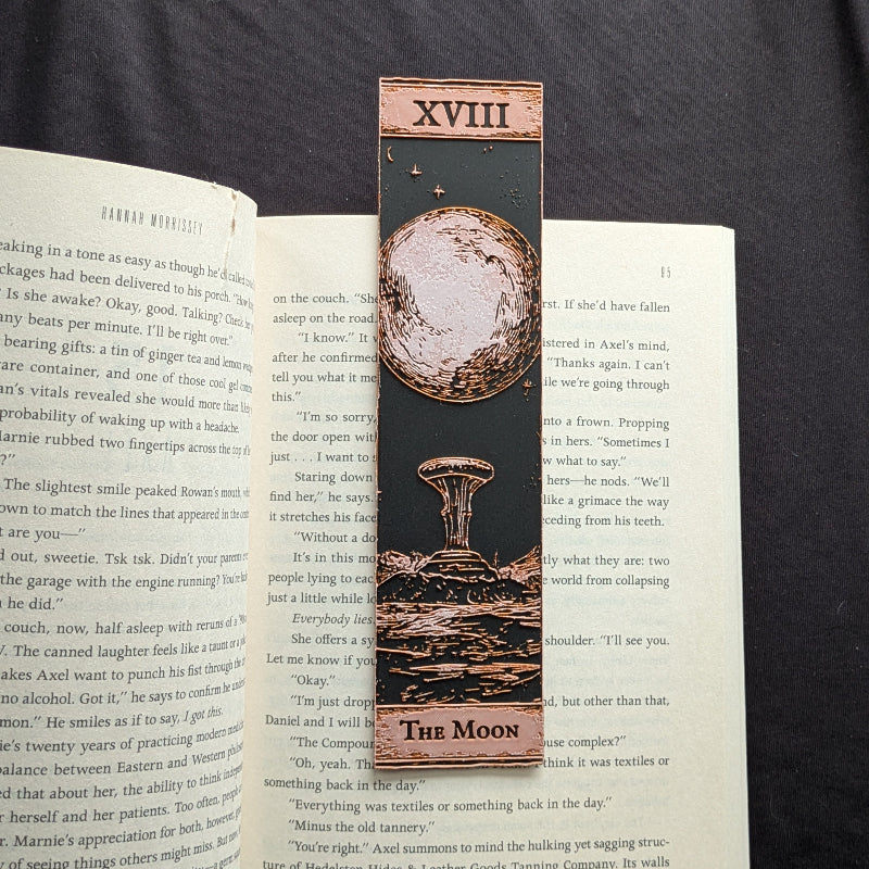 The Moon Classic Edition tarot bookmark featuring a pale full moon, small stars, and a detailed landscape on a dark background.