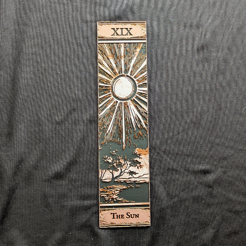 The Sun tarot bookmark in the Classic Edition showing the sun, radiating rays, and landscape
